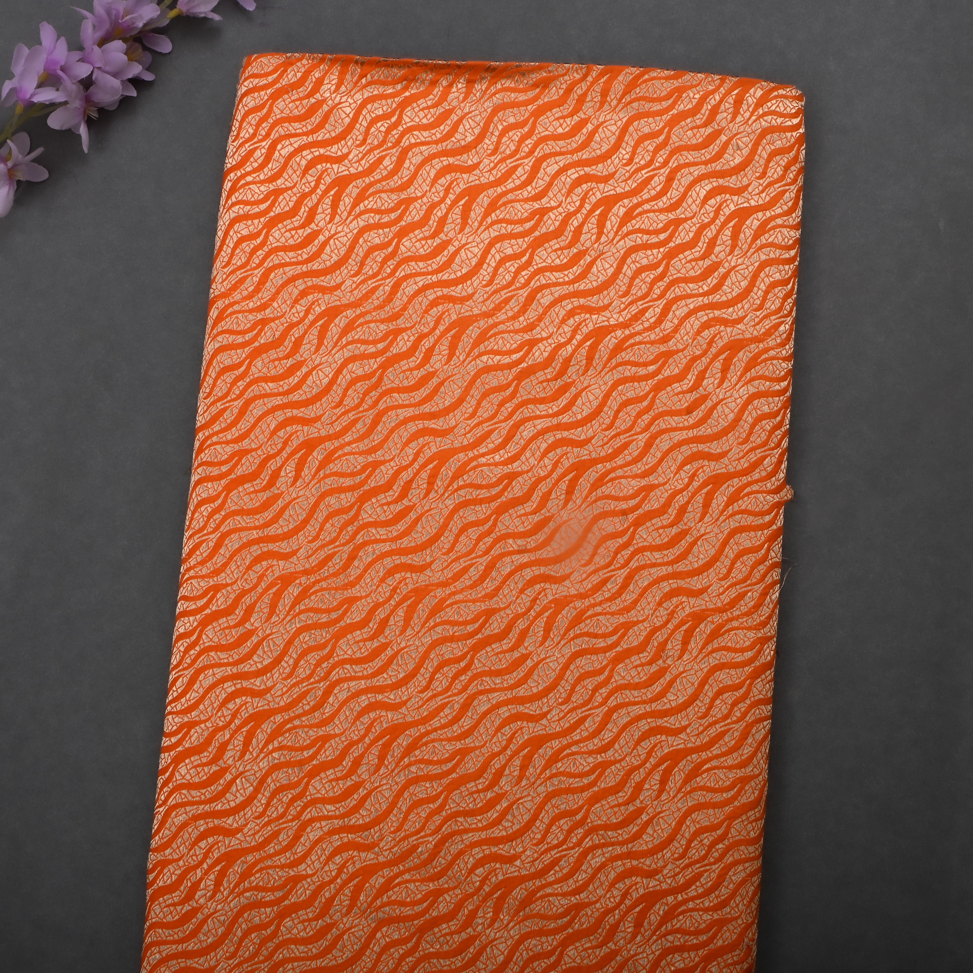 Rusty Orange Jamawar Silk Fabric With Wavy Pattern