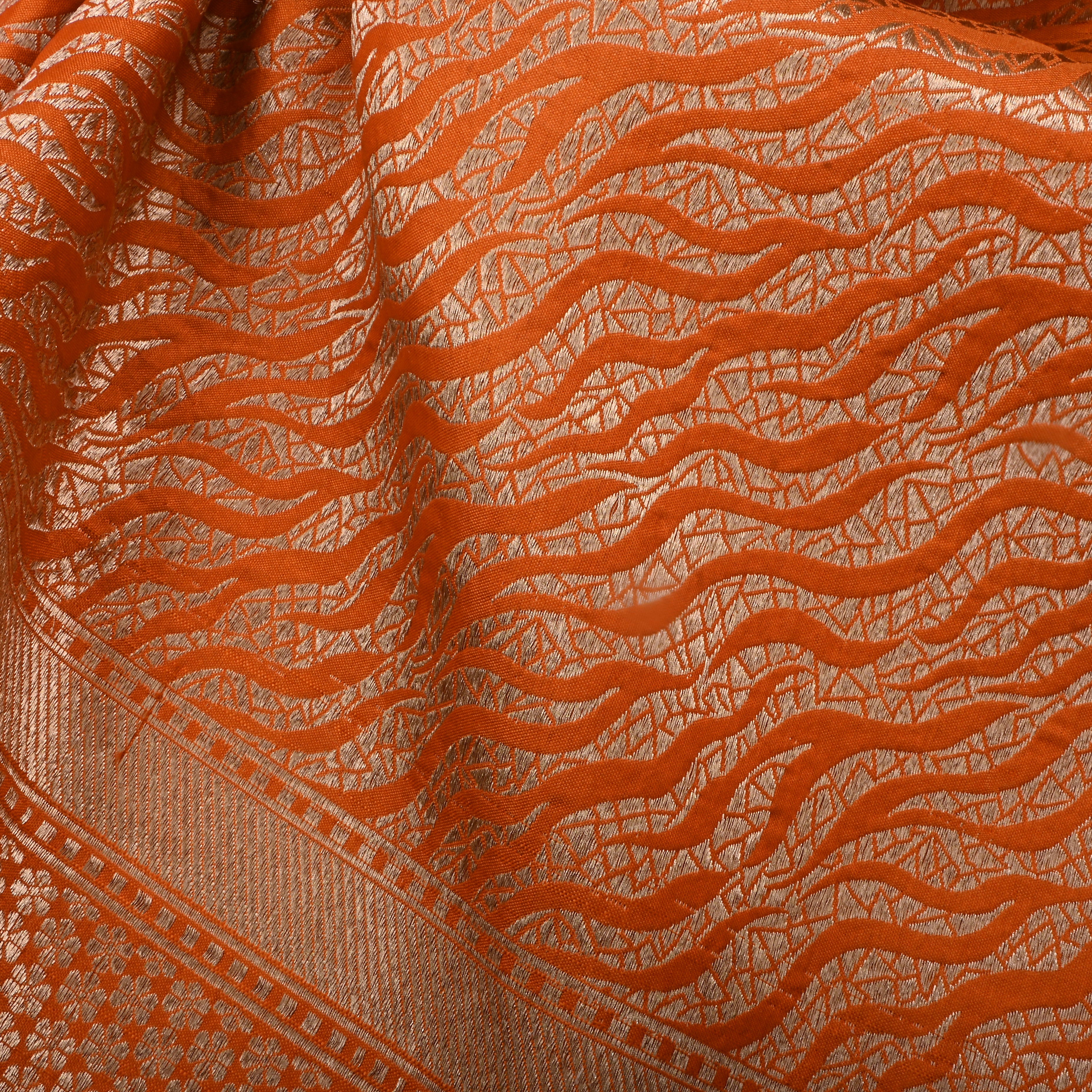 Rusty Orange Jamawar Silk Fabric With Wavy Pattern